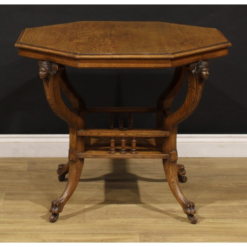 1527 - An unusual late 19th century oak octagonal centre table, moulded top above four carved mask corbels,... 