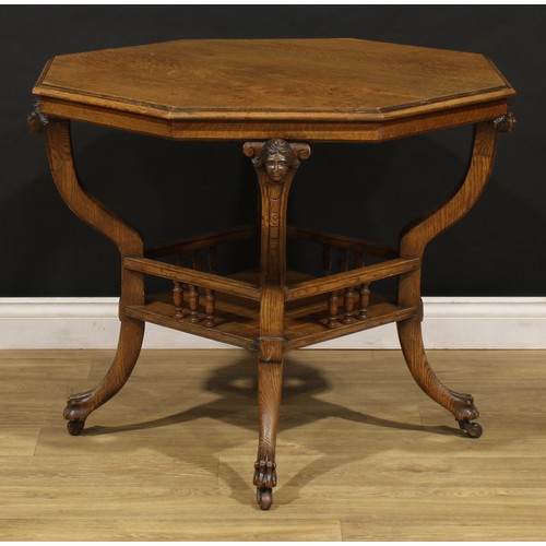 1527 - An unusual late 19th century oak octagonal centre table, moulded top above four carved mask corbels,... 