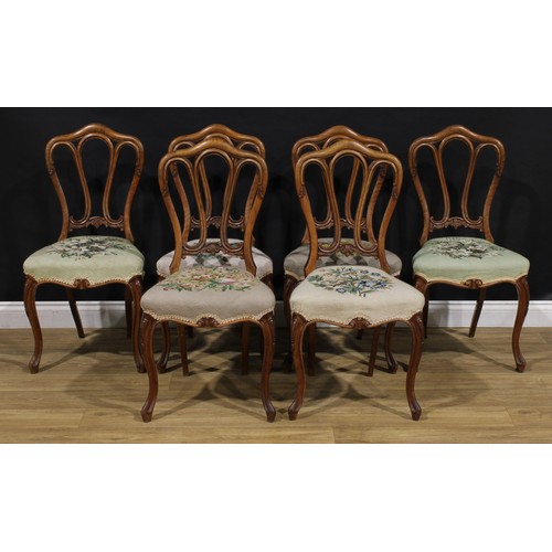 2456 - A set of six Victorian walnut dining chairs, in the French Provincial taste, stuffed-over needlework... 