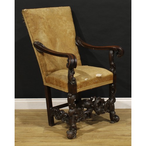 1519 - An Italian Baroque Revival armchair, stuffed-over upholstery, shaped arms terminating in leafy scrol... 