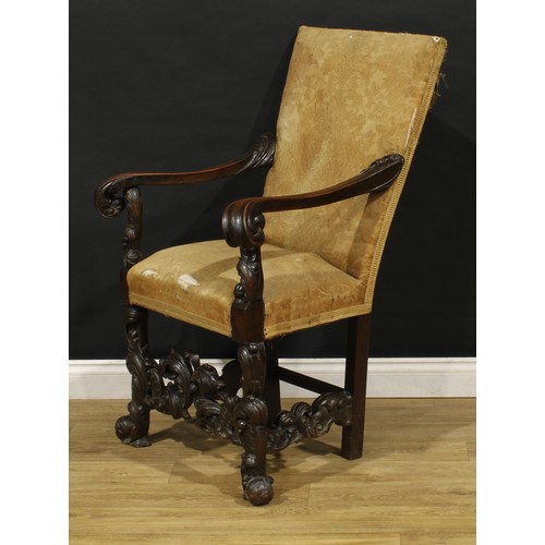 1519 - An Italian Baroque Revival armchair, stuffed-over upholstery, shaped arms terminating in leafy scrol... 