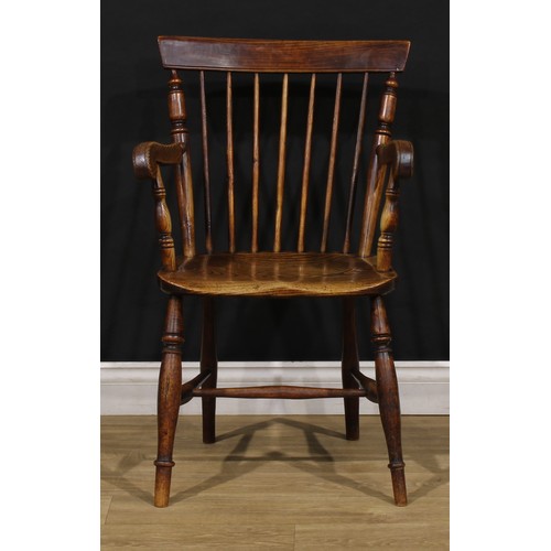 2406 - A 19th century vernacular elm and ash Windsor elbow chair, stick back with curved cresting rail flan... 