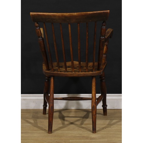 2406 - A 19th century vernacular elm and ash Windsor elbow chair, stick back with curved cresting rail flan... 