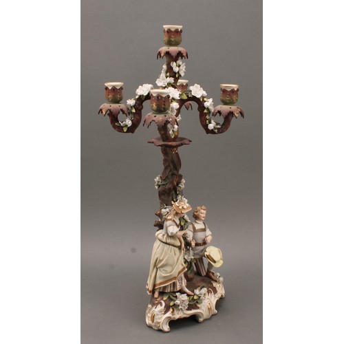 259 - A pair of Sitzendorf porcelain figural five-light candelabra, modelled as courting couples, each pai... 