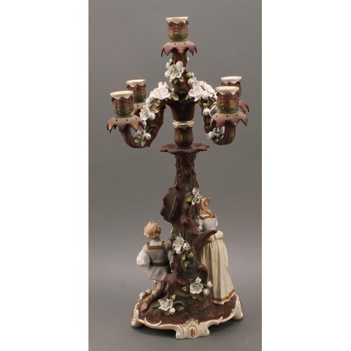 259 - A pair of Sitzendorf porcelain figural five-light candelabra, modelled as courting couples, each pai... 