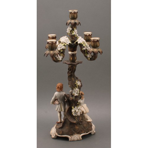 259 - A pair of Sitzendorf porcelain figural five-light candelabra, modelled as courting couples, each pai... 