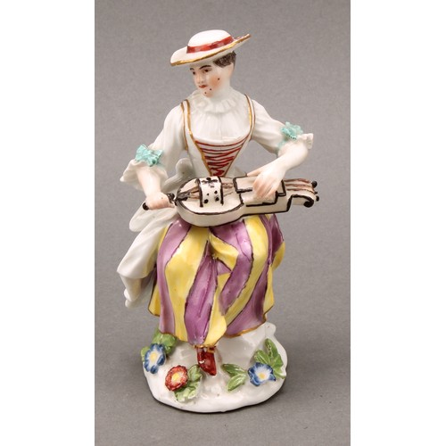 280 - An 18th century porcelain figure, Harlequin, he sits with bagpipes, blue crossed sword mark, 13.5cm ... 