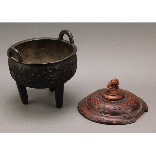 1277 - A Chinese bronze tripod censer, in the Archaic taste, hardwood cover with agate finial carved as a g... 