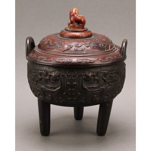 1277 - A Chinese bronze tripod censer, in the Archaic taste, hardwood cover with agate finial carved as a g... 