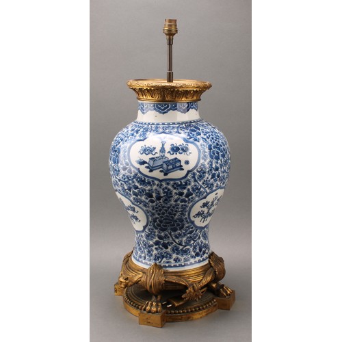 1305 - A large Chinese baluster vase, painted in tones of underglaze blue precious objects, within lotus sh... 