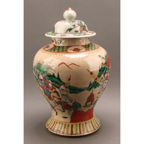 1294 - A Chinese baluster jar and cover, painted in polychrome enamels with warriors, on a crackle glaze gr... 