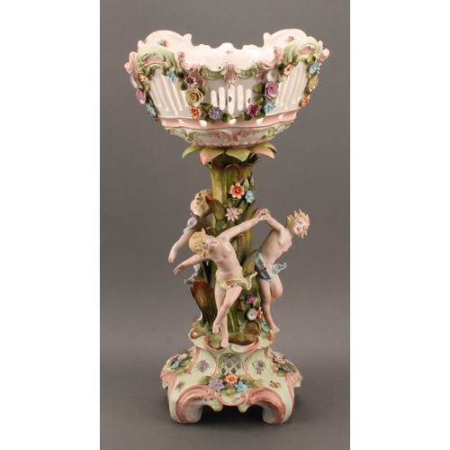 274 - A Sitzendorf porcelain figural table centre, moulded, printed and applied with putti and colourful s... 