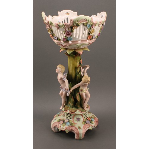 274 - A Sitzendorf porcelain figural table centre, moulded, printed and applied with putti and colourful s... 