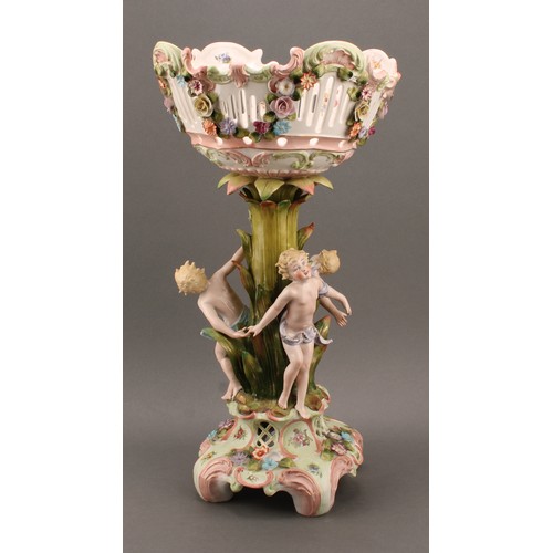 274 - A Sitzendorf porcelain figural table centre, moulded, printed and applied with putti and colourful s... 