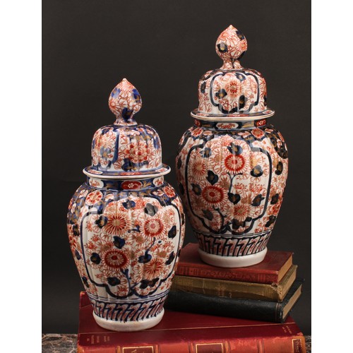 1365 - A pair of Japanese fluted ovoid vases and covers, painted in the Imari palette, 37cm high, Meiji per... 