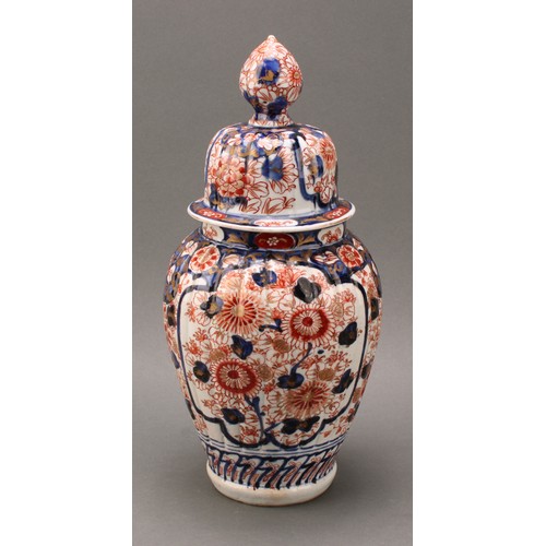 1365 - A pair of Japanese fluted ovoid vases and covers, painted in the Imari palette, 37cm high, Meiji per... 