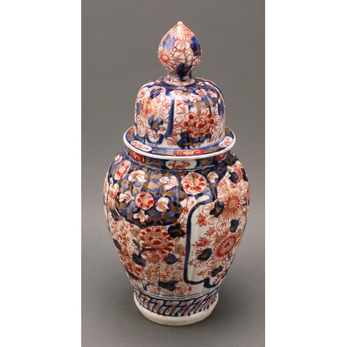 1365 - A pair of Japanese fluted ovoid vases and covers, painted in the Imari palette, 37cm high, Meiji per... 