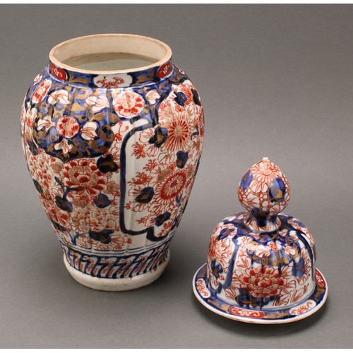 1365 - A pair of Japanese fluted ovoid vases and covers, painted in the Imari palette, 37cm high, Meiji per... 