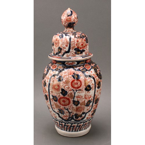 1365 - A pair of Japanese fluted ovoid vases and covers, painted in the Imari palette, 37cm high, Meiji per... 