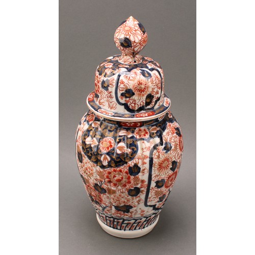 1365 - A pair of Japanese fluted ovoid vases and covers, painted in the Imari palette, 37cm high, Meiji per... 