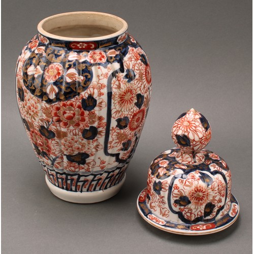 1365 - A pair of Japanese fluted ovoid vases and covers, painted in the Imari palette, 37cm high, Meiji per... 