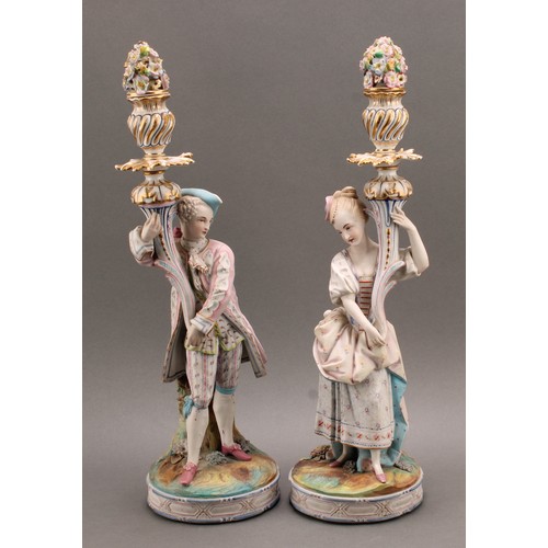 246 - A pair of Continental bisque porcelain figural candlesticks, as a courting couple in 18th century dr... 