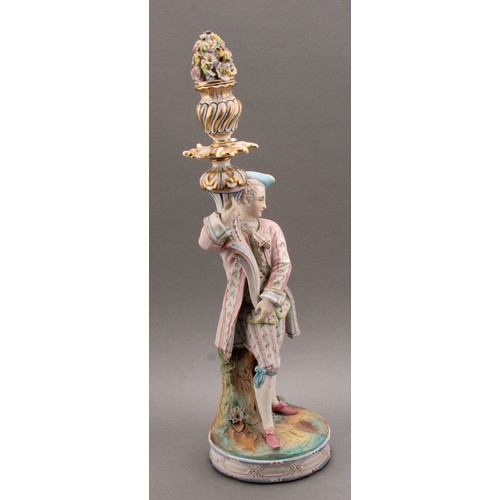 246 - A pair of Continental bisque porcelain figural candlesticks, as a courting couple in 18th century dr... 