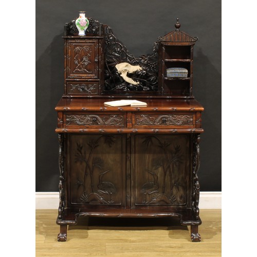 1891 - A Chinese export hardwood desk, shaped superstructure with panel door, small drawer and open shelves... 