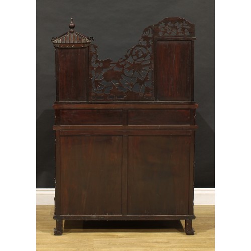 1891 - A Chinese export hardwood desk, shaped superstructure with panel door, small drawer and open shelves... 