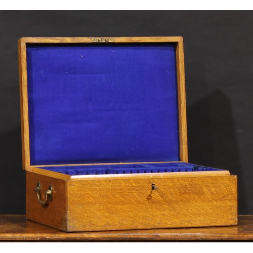 2344 - An early 20th century oak canteen, hinged cover inlaid with a vacant brass shield shaped cartouche a... 