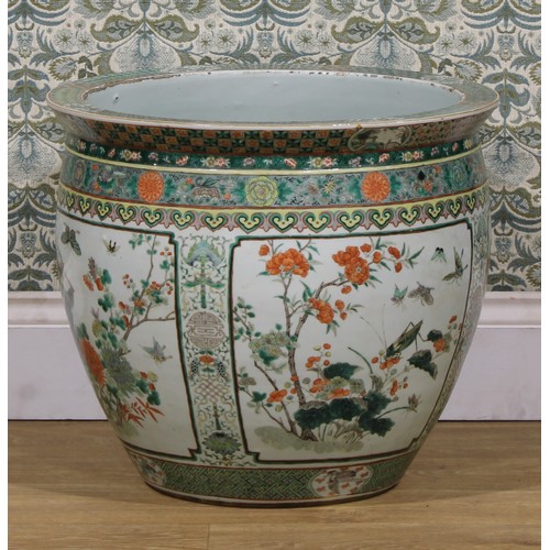 1307 - A large Chinese ovoid fish bowl, painted in the famille verte palette with birds, flowers and insect... 