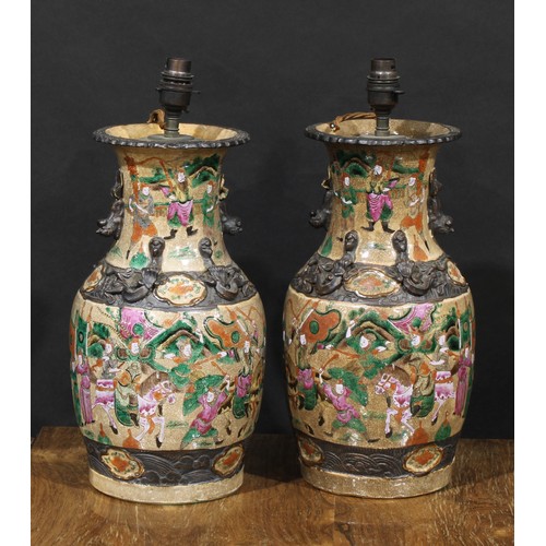 1362 - A pair of Chinese baluster vases, painted in polychrome enamels with with warriors, on a crackle gla... 