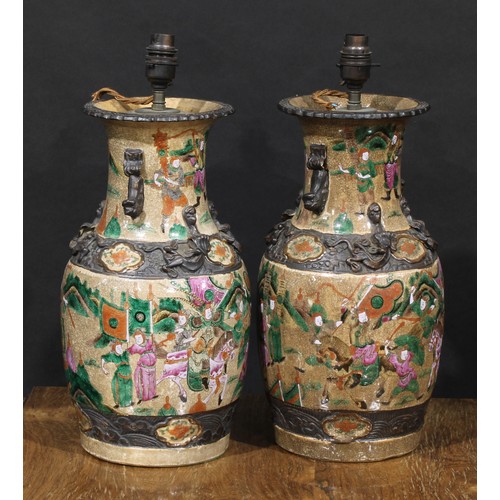 1362 - A pair of Chinese baluster vases, painted in polychrome enamels with with warriors, on a crackle gla... 