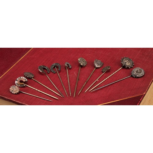 1404 - Stick Pins - a late 19th century sterling silver pin with horse shoe terminal, detailed with rose go... 