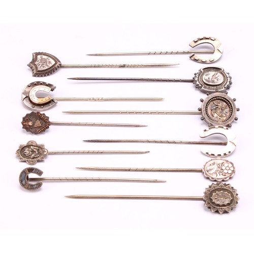 1404 - Stick Pins - a late 19th century sterling silver pin with horse shoe terminal, detailed with rose go... 