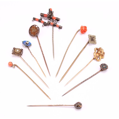 1403 - Stick Pins - a late 19th century pin the terminal as a carved coral rose bud, 7.5cm; others, coral a... 