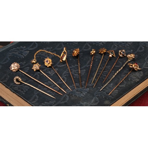 1400 - Stick Pins - a late 19th century 15ct gold wishbone pin, set with a single red stone, with safety ch... 