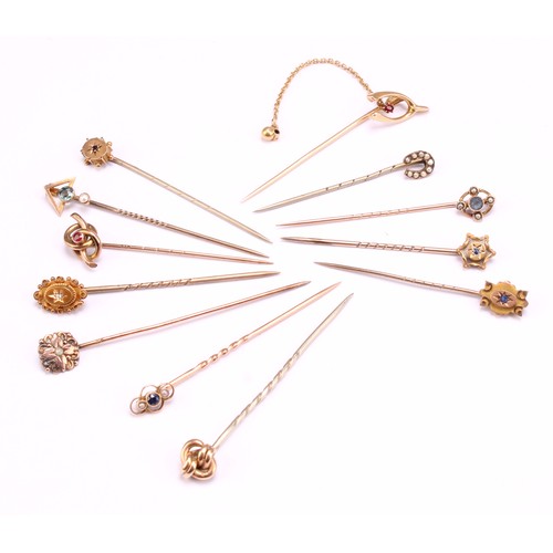 1400 - Stick Pins - a late 19th century 15ct gold wishbone pin, set with a single red stone, with safety ch... 