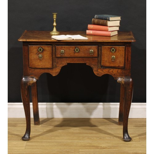 2360 - A George II oak lowboy, rounded rectangular moulded oversailing top above three frieze drawers, shap... 