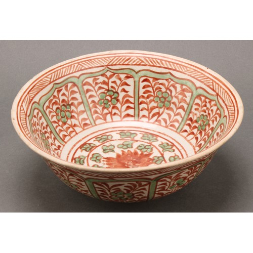 1311 - A Middle Eastern pottery circular bowl, decorated in the Islamic taste in tones of red and green wit... 