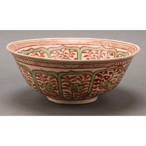 1311 - A Middle Eastern pottery circular bowl, decorated in the Islamic taste in tones of red and green wit... 