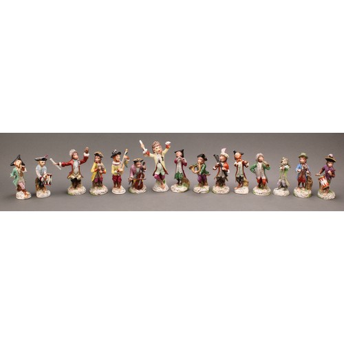 31 - A German porcelain monkey band, inspired by models by Kändler, the conductor 15.5cm high