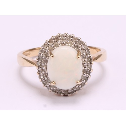 1192 - A 9ct gold white opal and diamond cluster ring, consisting of an oval cabochon opal that measures ap... 