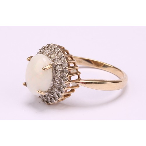 1192 - A 9ct gold white opal and diamond cluster ring, consisting of an oval cabochon opal that measures ap... 