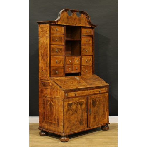 2413 - An 18th century German walnut bureau cabinet, architectural pediment above an arrangement of drawers... 