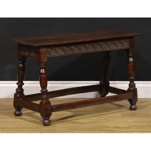 1882 - A 17th century style oak joint stool, rectangular top with moulded edge, the frieze carved with leaf... 