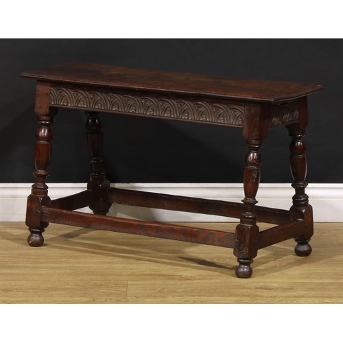 1882 - A 17th century style oak joint stool, rectangular top with moulded edge, the frieze carved with leaf... 