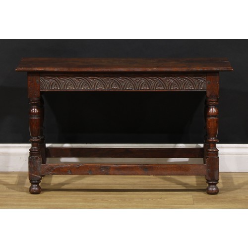 1882 - A 17th century style oak joint stool, rectangular top with moulded edge, the frieze carved with leaf... 