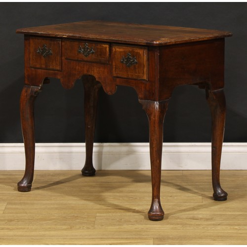 1497 - A George II walnut lowboy, moulded top above three frieze drawers, shaped apron, cabriole legs, pad ... 