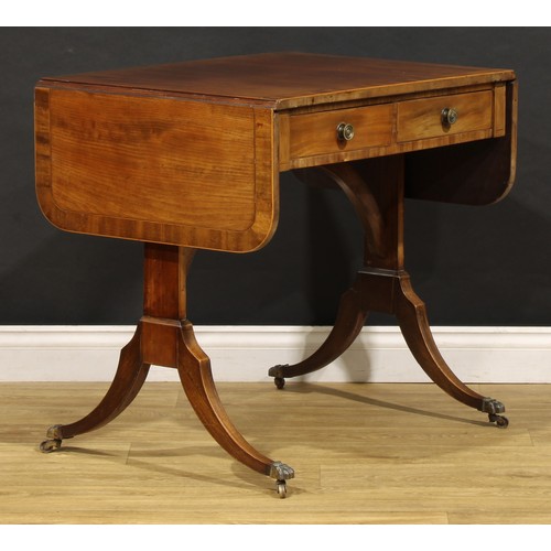 2094 - A 19th century mahogany sofa table, in the Regency taste, rounded rectangular top with fall leaves a... 